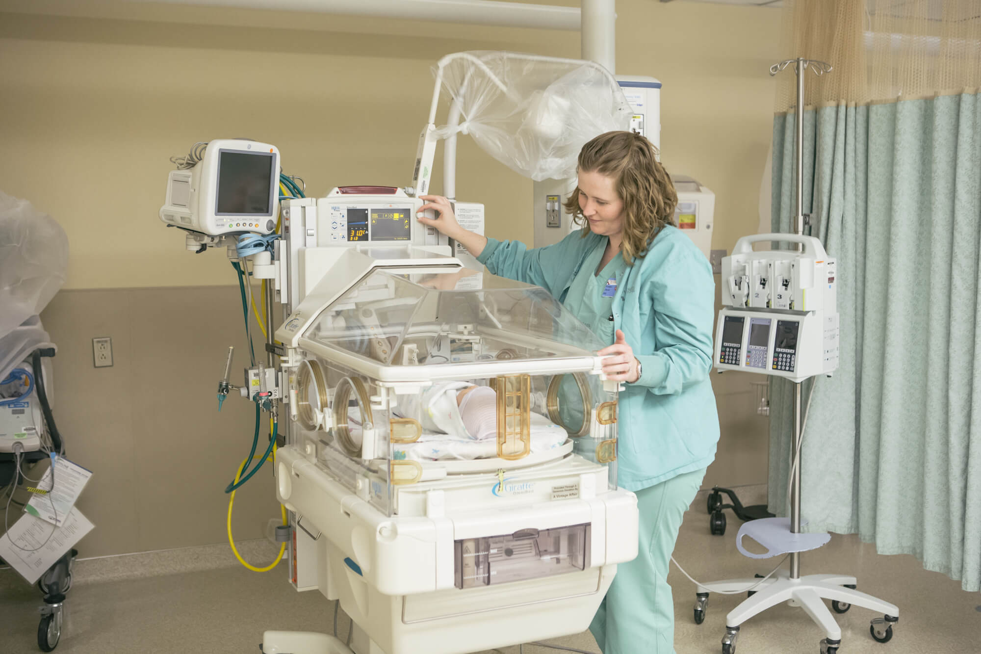 NICU2 image with nurse over baby