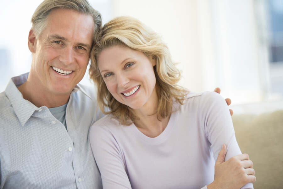 Mature couple smiling together at home